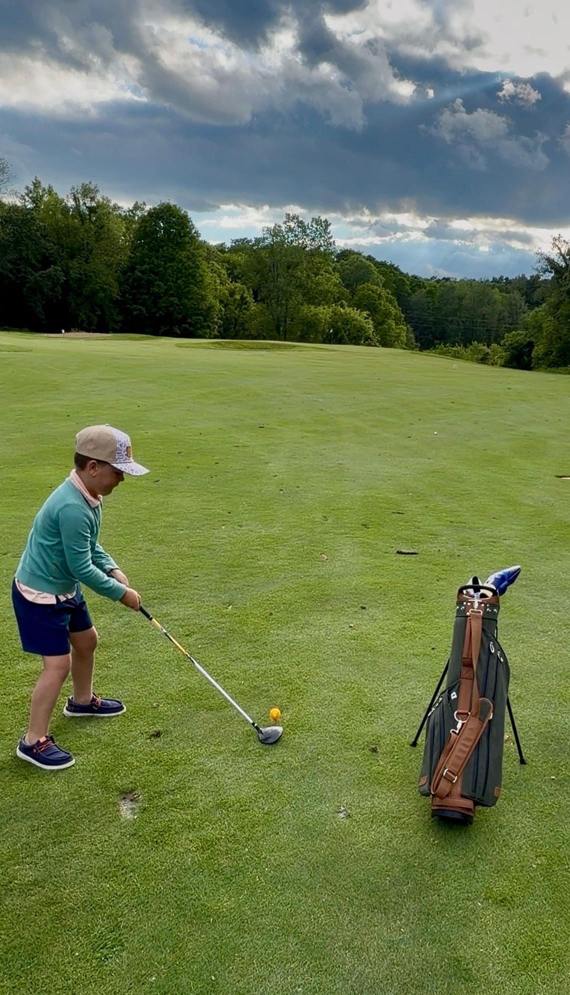 Child playing golf with premium youth golf bag
