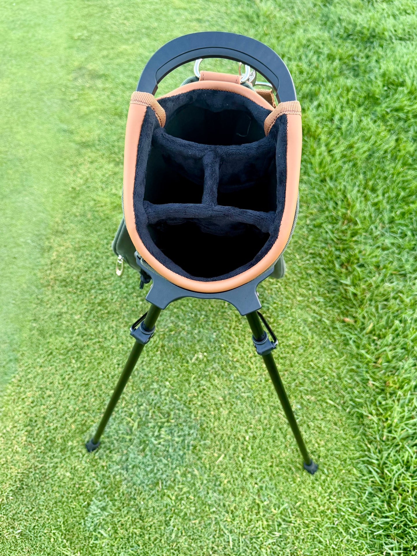 Golf bag with stand on a grassy background