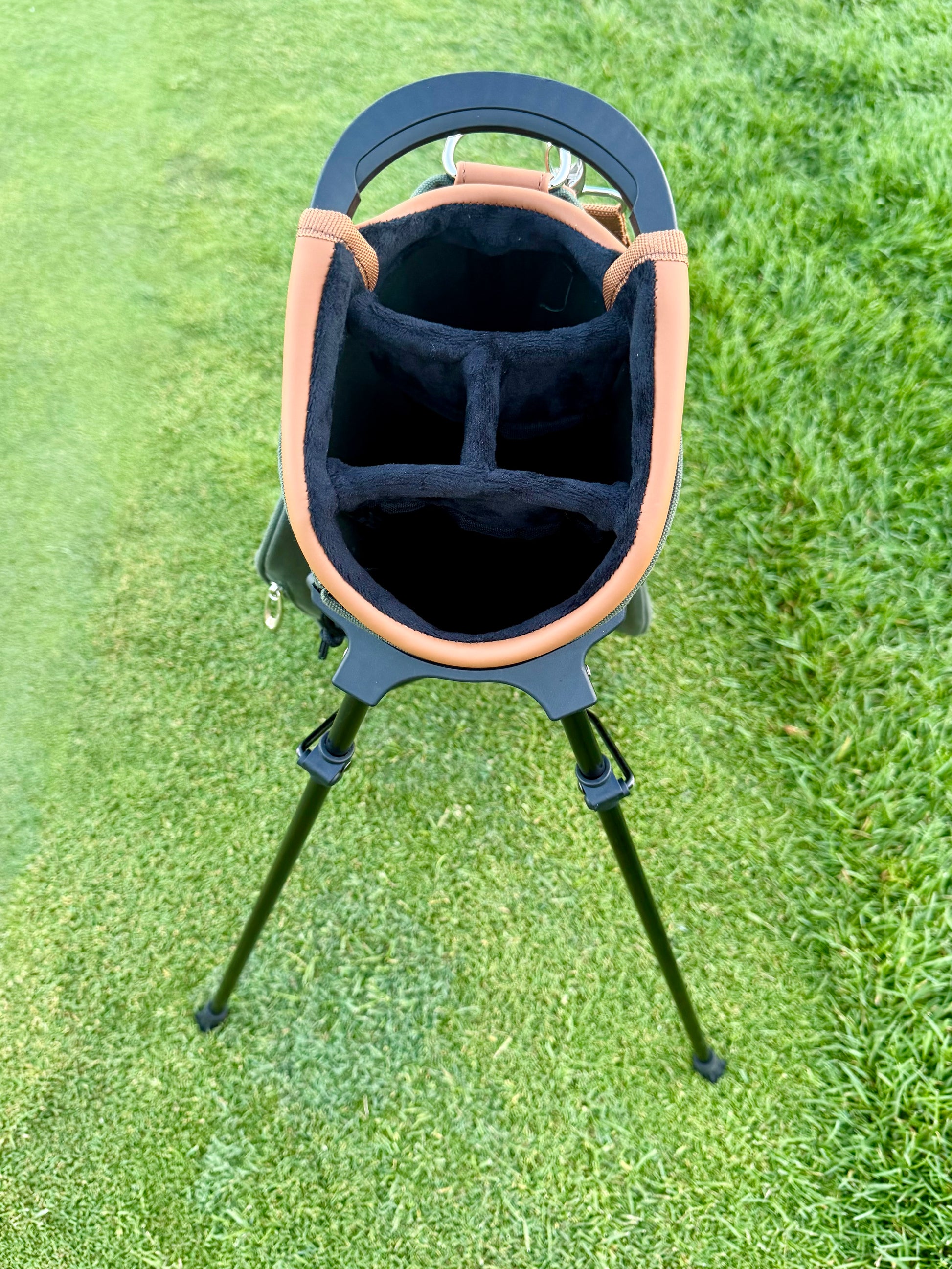 Golf bag with stand on a grassy background